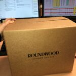 a cardboard packaging box for roundwood gin bottles