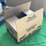 A cardboard box made for the Emmerdale props department, partly open